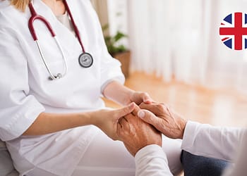 Doctor holding a patient's hands in a healthcare setting.